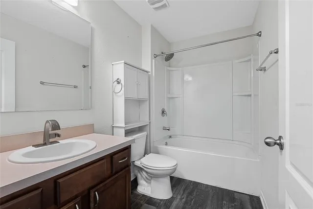 a bathroom with a sink toilet tub and shower