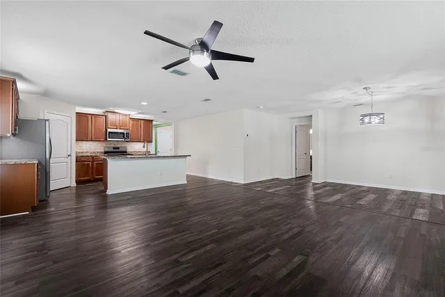 a view of a kitchen with a sink dishwasher cabinets and wooden floor