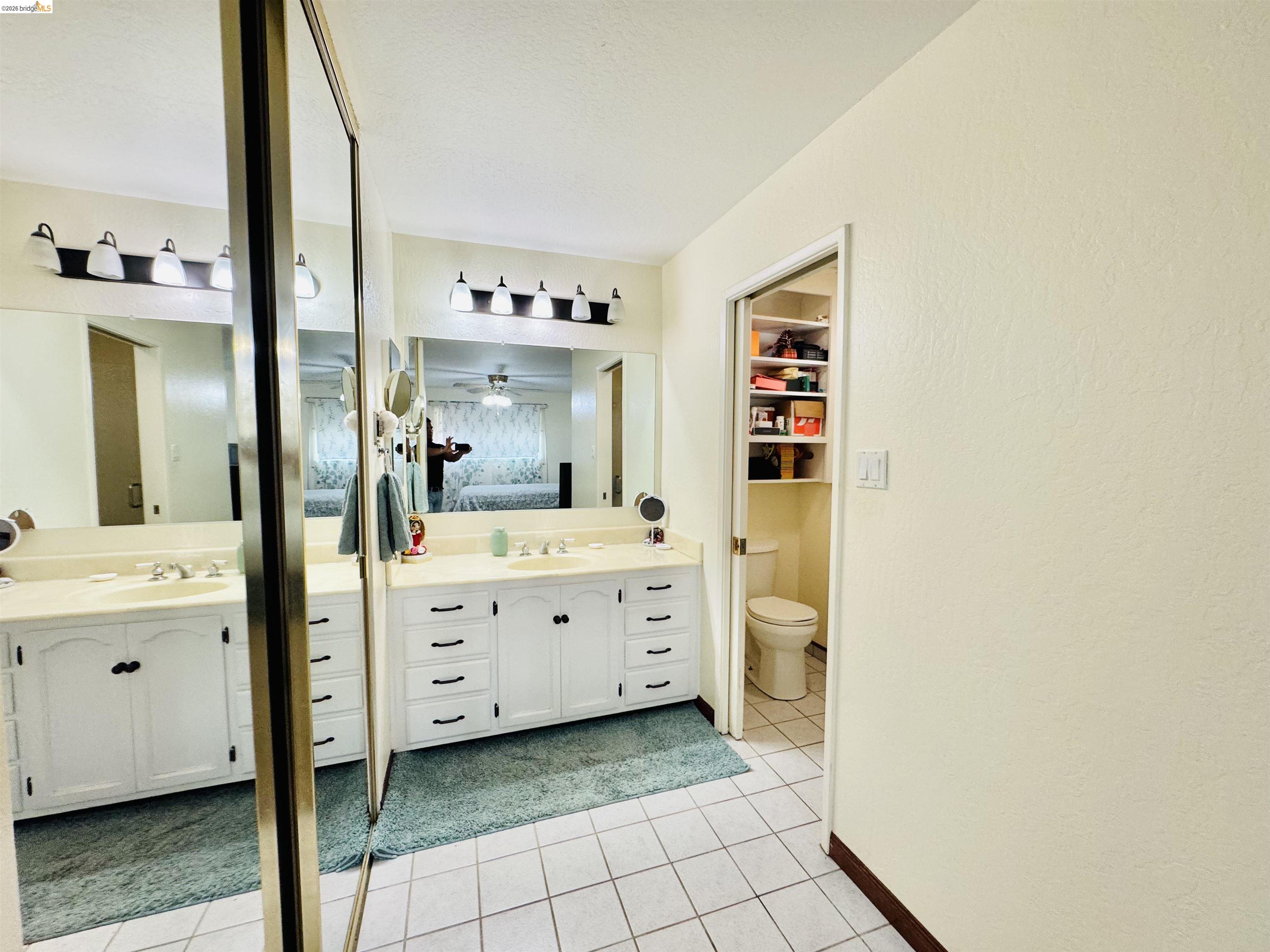 3513 Rio Grande Drive Antioch, CA 94509 - Photo 16 of 22 Dual vanity with integrated sinks and ample storage, featuring a full-width mirror and contemporary vanity lighting