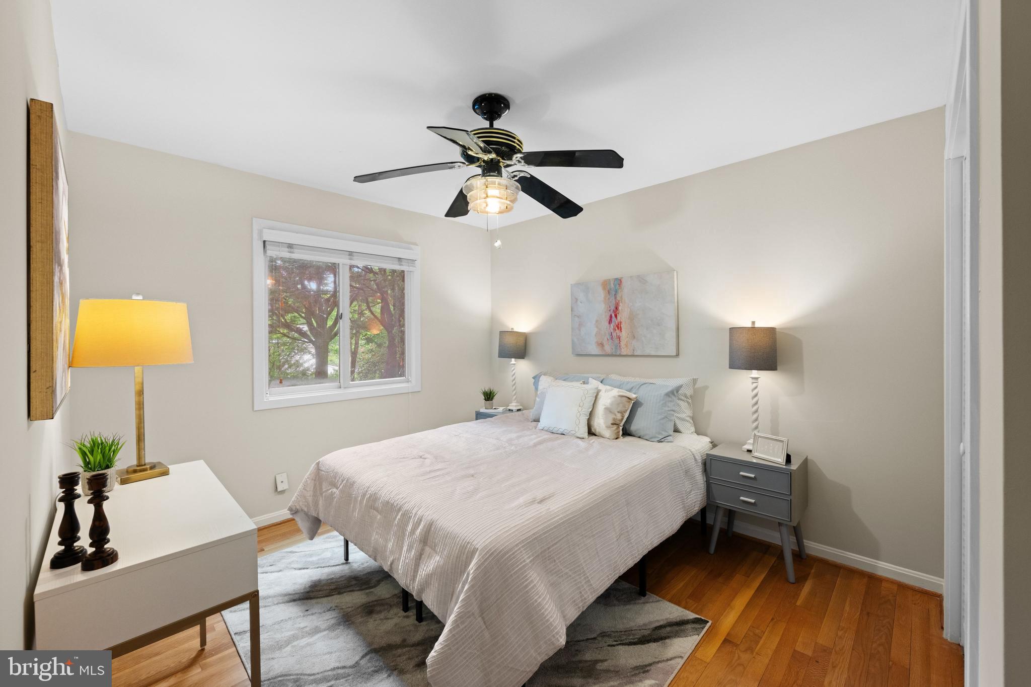 3529 Yuma Street Northwest Washington, DC 20008 - Photo 20 of 46 a bedroom with a bed and a lamp on table and a window