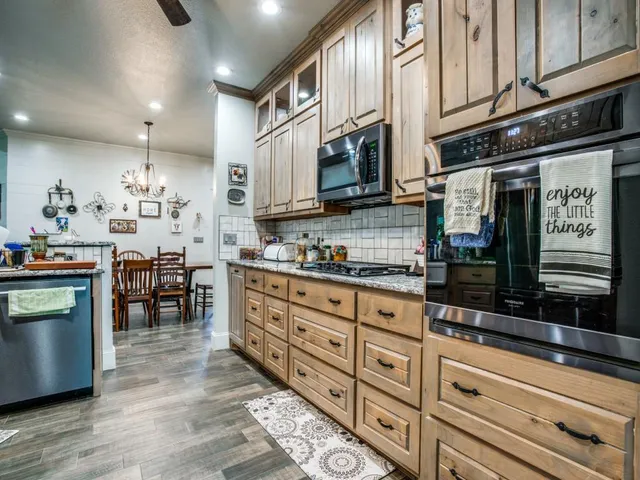 a kitchen with stainless steel appliances granite countertop a stove and a sink