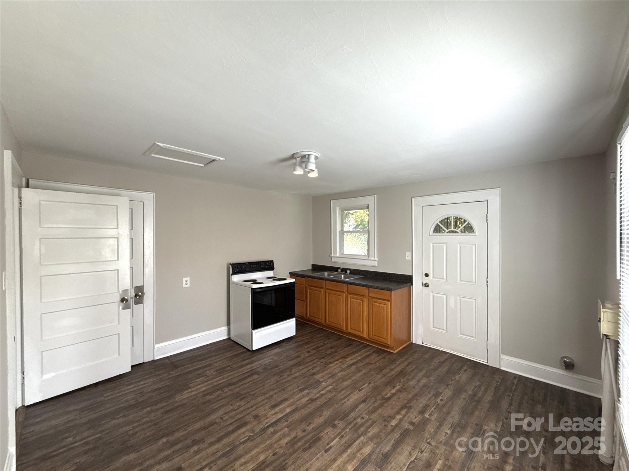 904 Harrill Street Charlotte, NC 28205 - Photo 8 of 11 a kitchen with granite countertop a refrigerator and a stove top oven