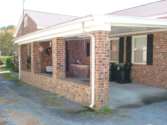 a dining table chairs in a kitchen next to a window