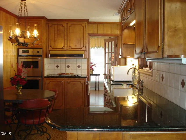 a living room with a rug and a table