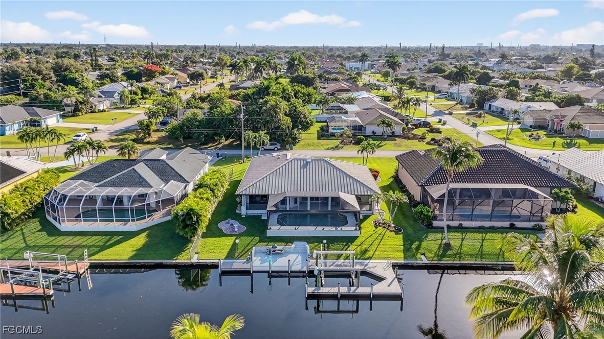 4306 Southwest 3rd Avenue Cape Coral, FL 33914 - Photo 41 of 50 an aerial view of residential houses with swimming pool and outdoor seating