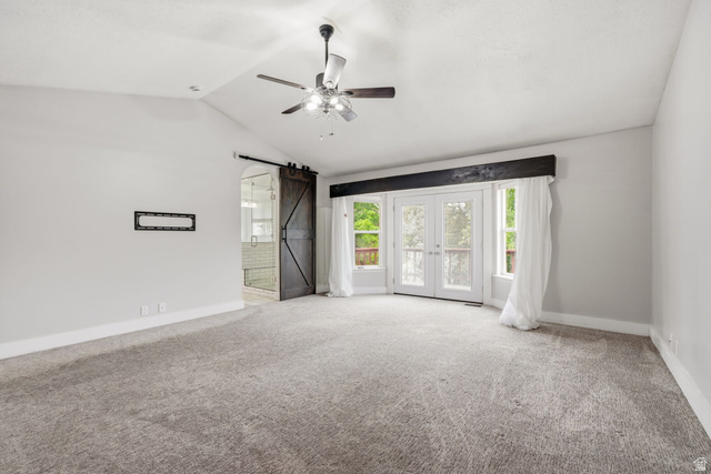 2154 Wasatch Boulevard Sandy, UT 84092 - Photo 18 of 32 Spacious interior featuring a vaulted ceiling with a ceiling fan, plush grey carpeting, and light grey wall finishes