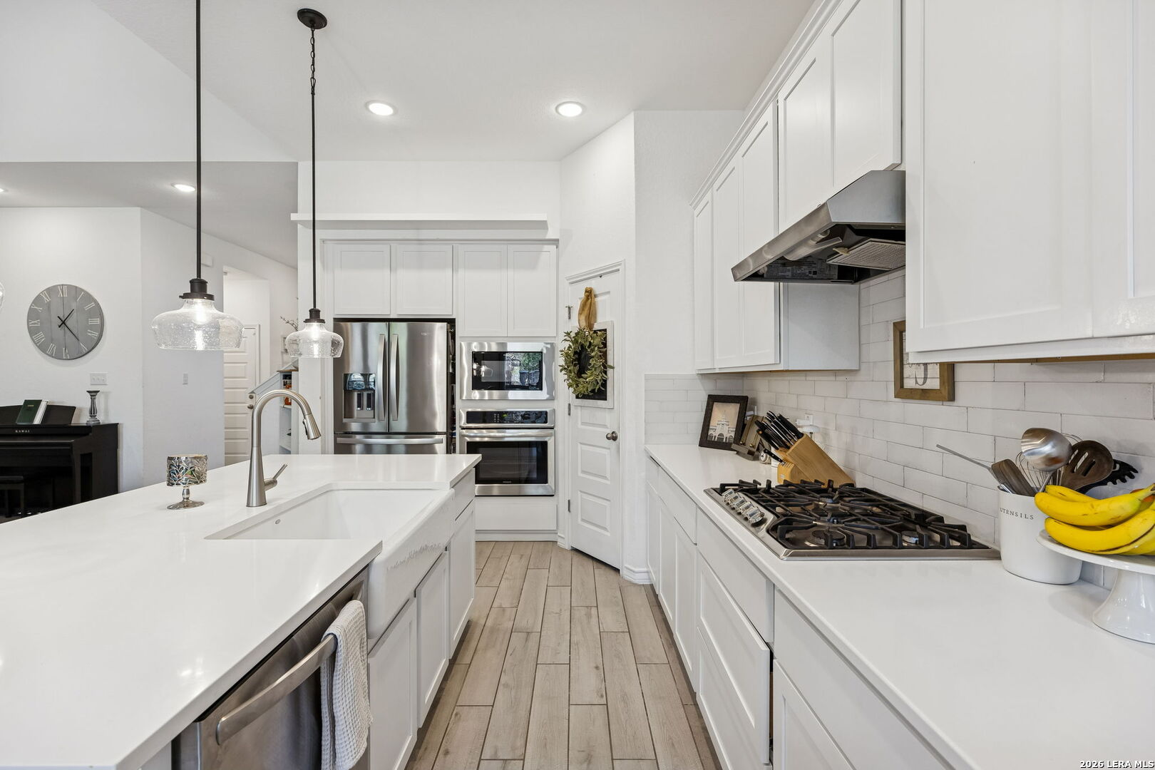 12260 Buckaroo Ranch San Antonio, TX 78254 - Photo 15 of 45 a kitchen with a sink a stove and chairs