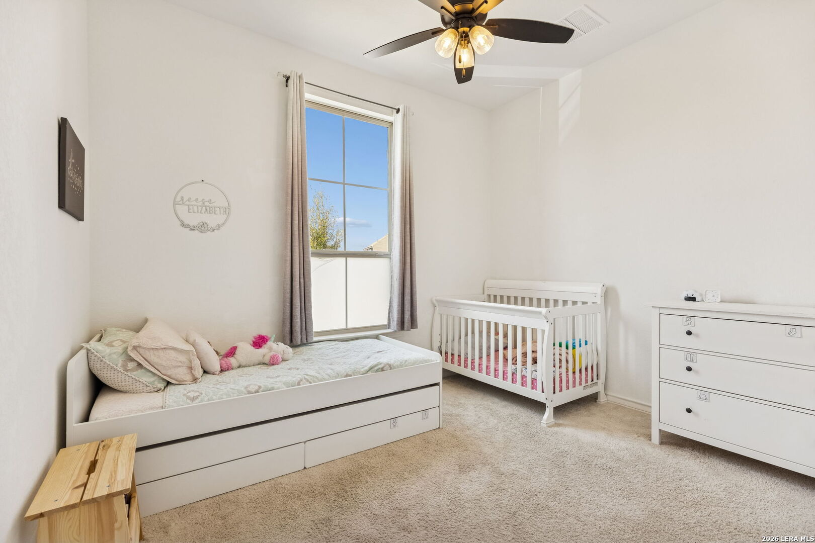 12260 Buckaroo Ranch San Antonio, TX 78254 - Photo 19 of 45 a bedroom with a bed and a chandelier