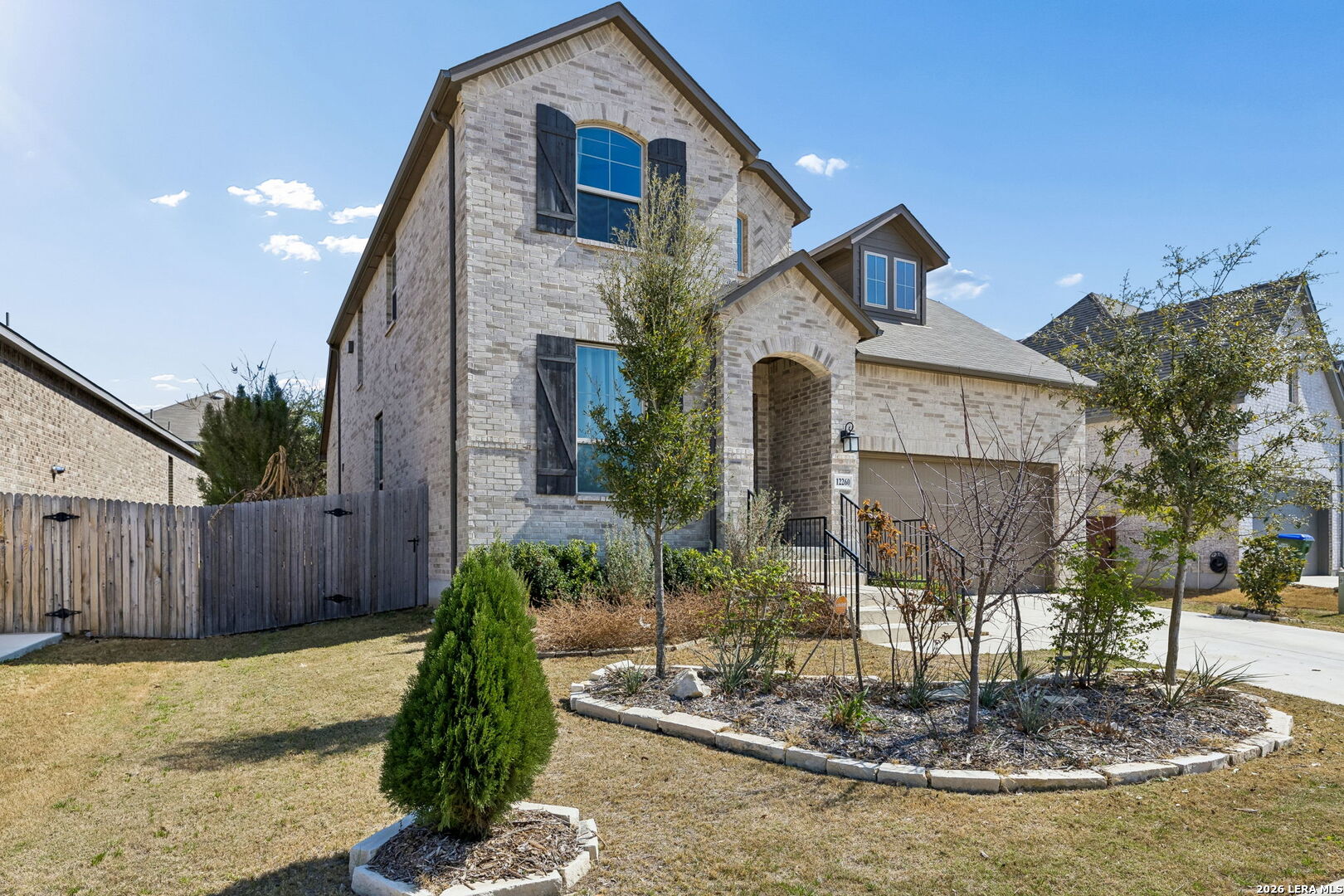 12260 Buckaroo Ranch San Antonio, TX 78254 - Photo 2 of 45 a front view of a house with garden