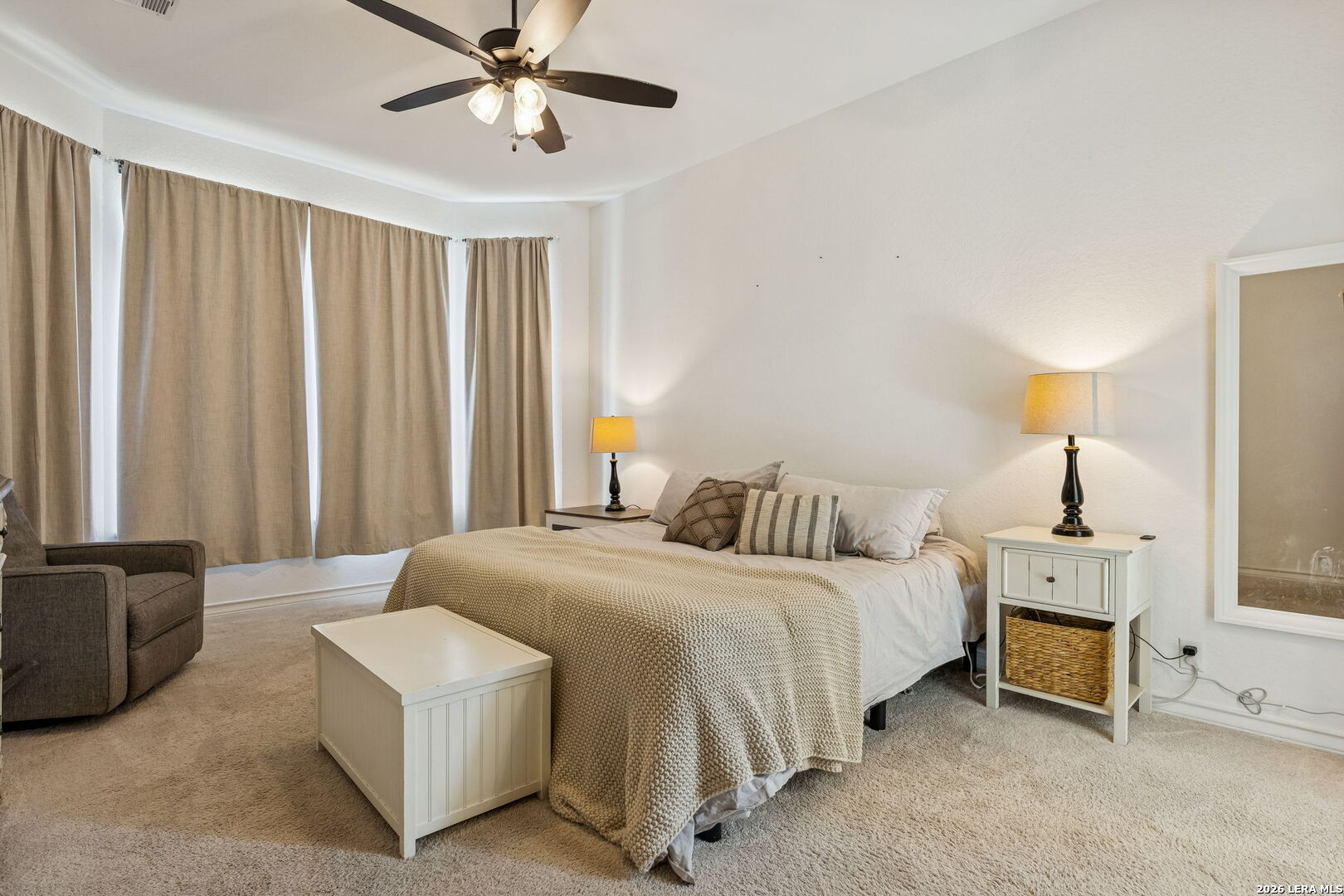 12260 Buckaroo Ranch San Antonio, TX 78254 - Photo 21 of 45 a bedroom with a bed and a chandelier