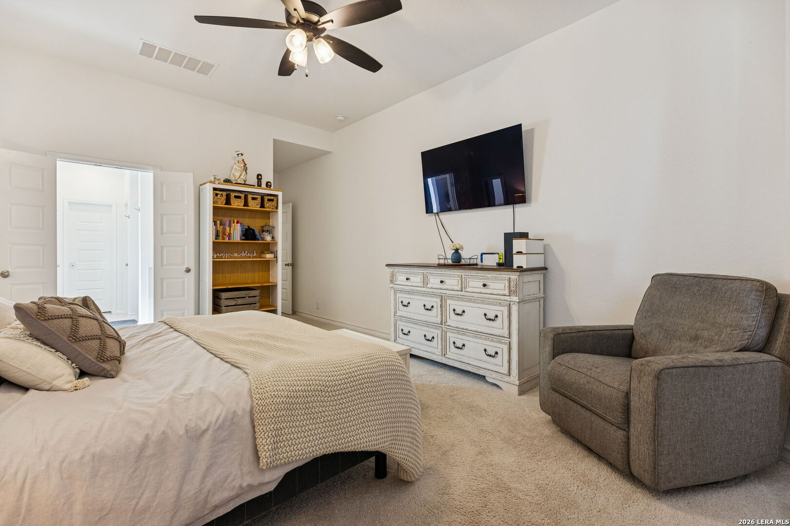 12260 Buckaroo Ranch San Antonio, TX 78254 - Photo 22 of 45 a bedroom with a bed a couch and a flat screen tv