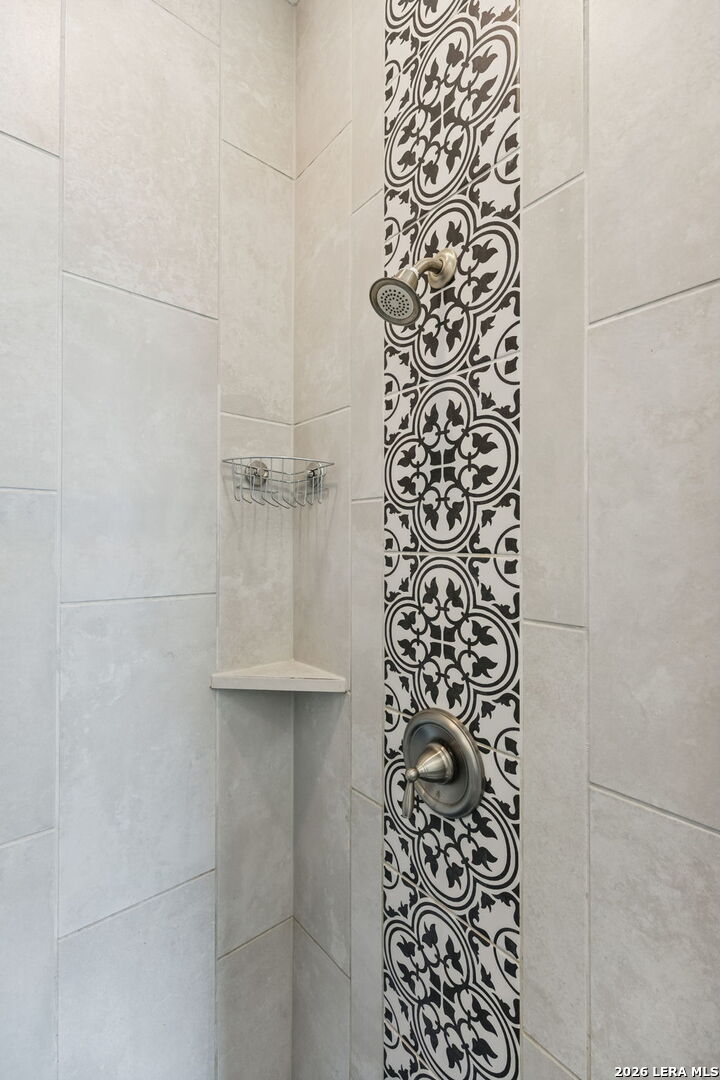 12260 Buckaroo Ranch San Antonio, TX 78254 - Photo 24 of 45 a bathroom with a shower curtain and a sink