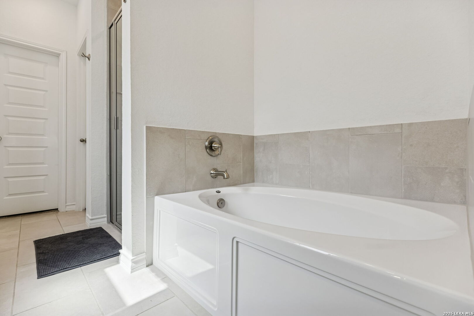 12260 Buckaroo Ranch San Antonio, TX 78254 - Photo 25 of 45 a spacious bathroom with a tub sink and mirror