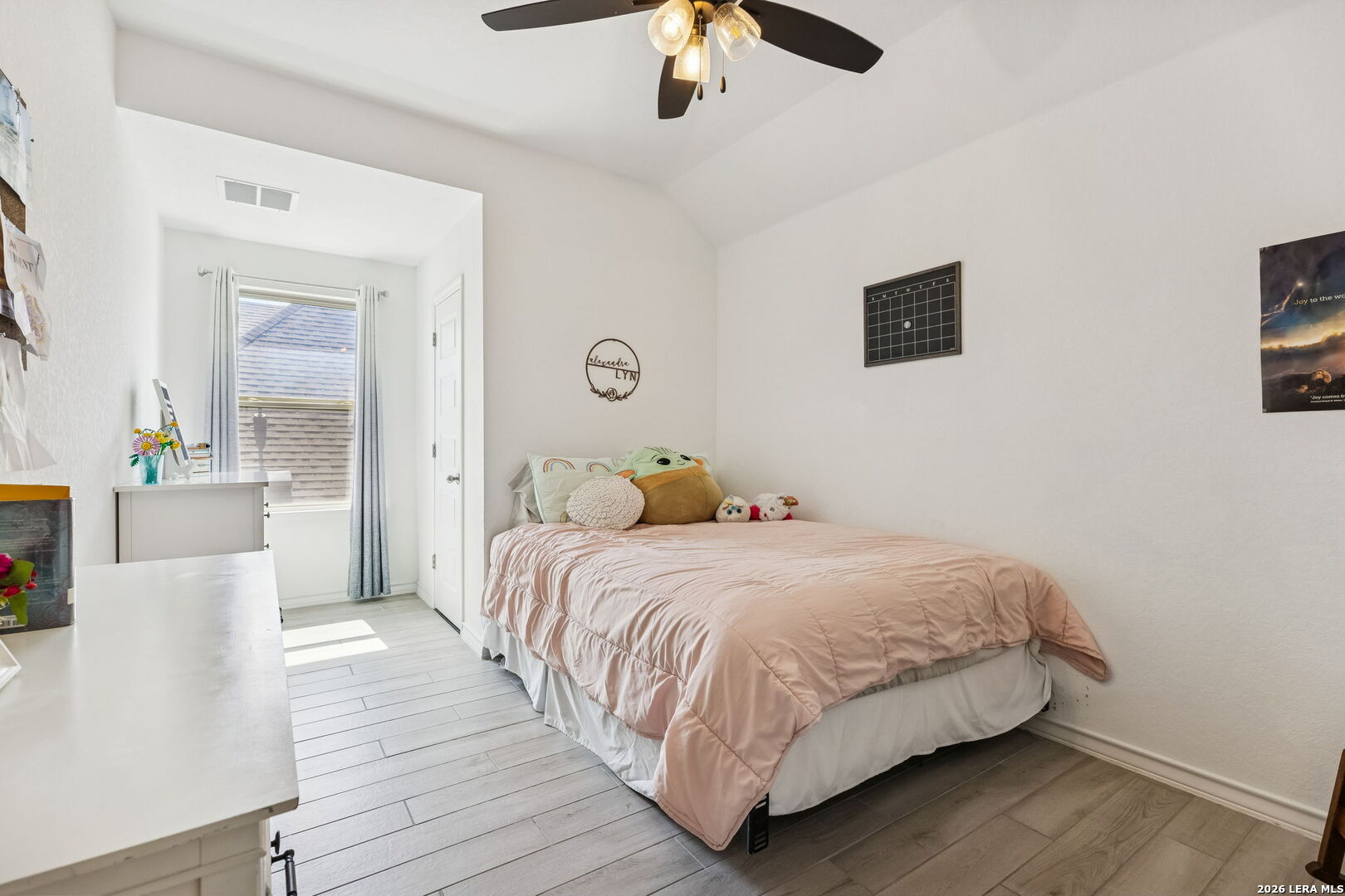 12260 Buckaroo Ranch San Antonio, TX 78254 - Photo 27 of 45 a bedroom with a bed and a chandelier