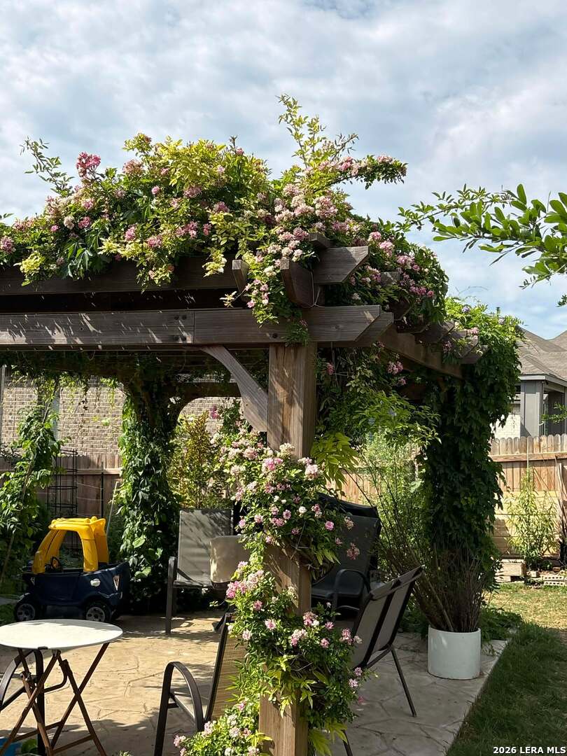12260 Buckaroo Ranch San Antonio, TX 78254 - Photo 33 of 45 a view of a garden with a bench and some trees