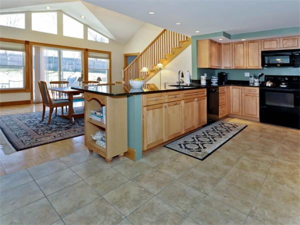 21 Appleton Road Natick, MA 01760 - Photo 14 of 25 a kitchen with stainless steel appliances granite countertop a stove a sink and a microwave