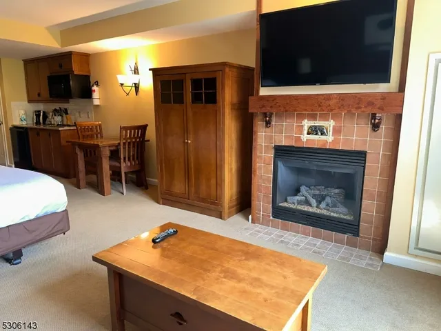 a spacious bedroom with a bed and wooden floor