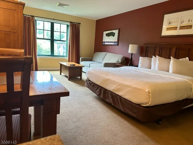 a kitchen with granite countertop a refrigerator and a sink