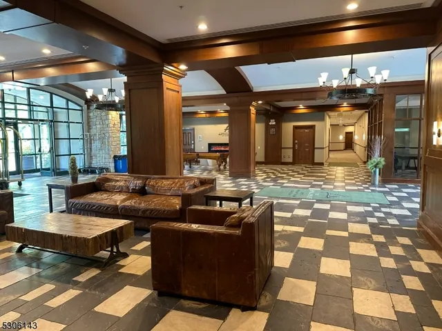 a view of a hall with a dining table and chairs with outer view