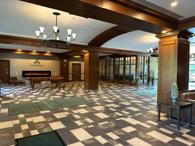 a living room with furniture a window and flat screen tv