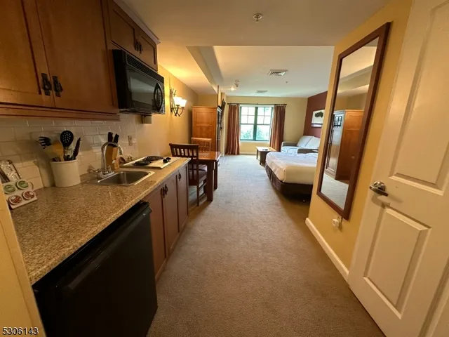 a kitchen with a sink a microwave and cabinets