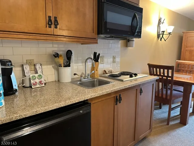 a kitchen with granite countertop a sink and cabinets