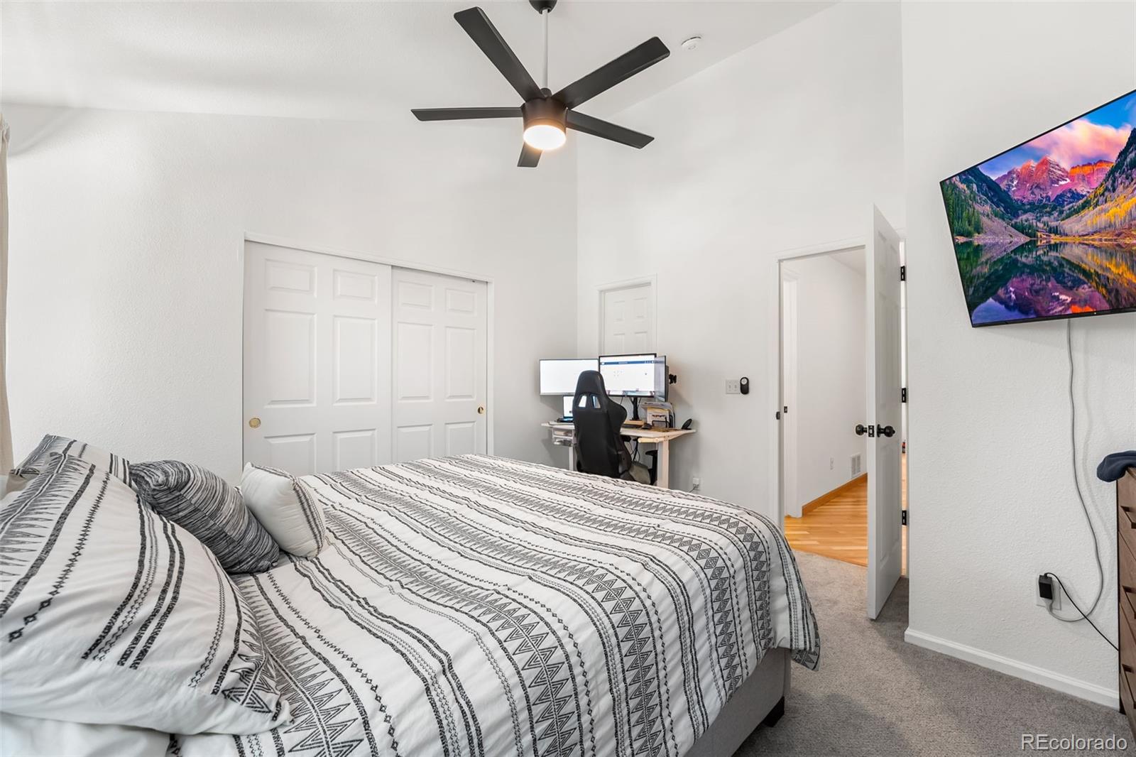 152 Pheasant Run Louisville, CO 80027 - Photo 17 of 30 a bedroom with a bed and a chandelier