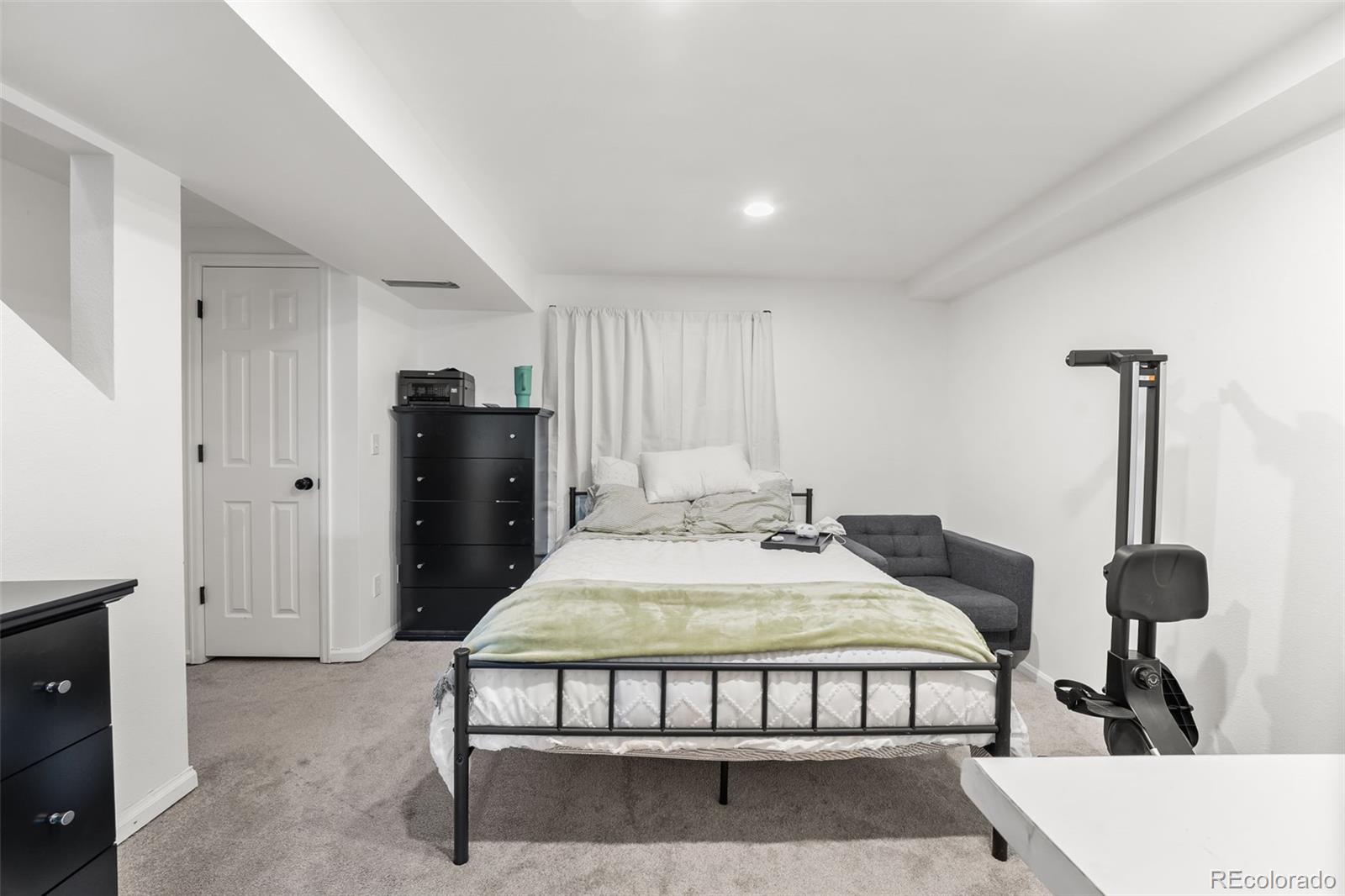 152 Pheasant Run Louisville, CO 80027 - Photo 23 of 30 a bedroom with a bed and wooden floor