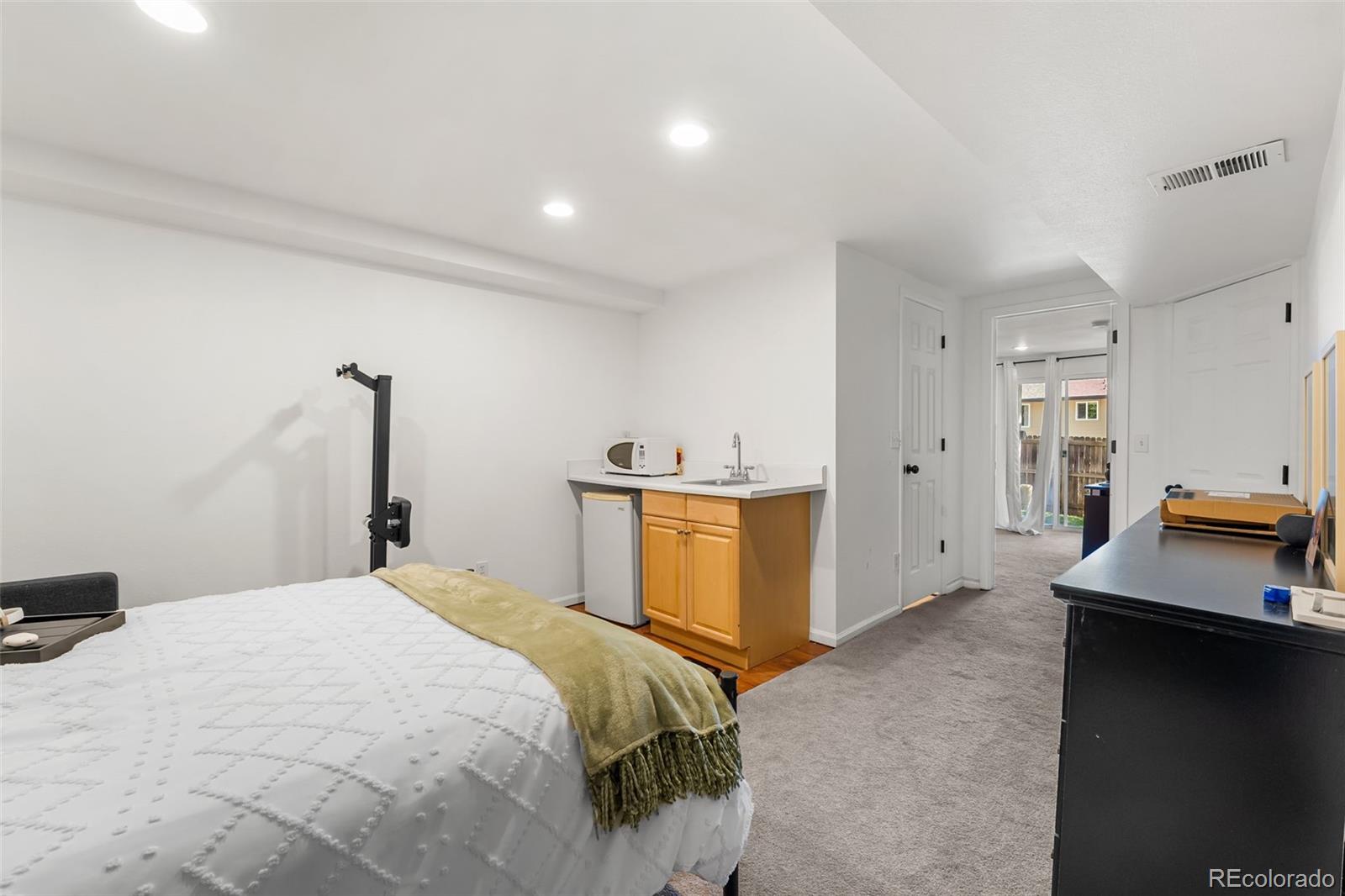 152 Pheasant Run Louisville, CO 80027 - Photo 24 of 30 a bedroom with a bed and a view of cabinet