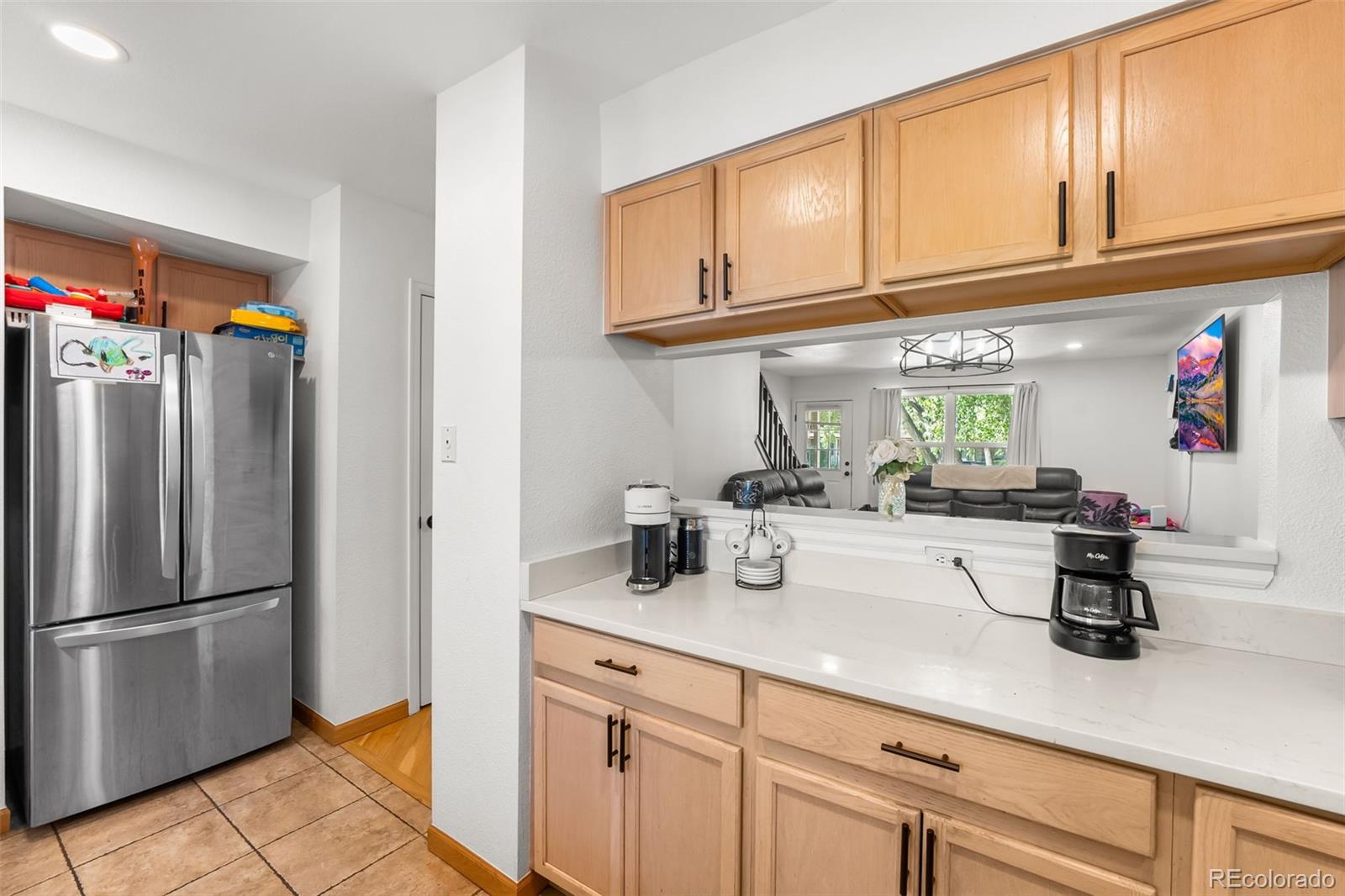 152 Pheasant Run Louisville, CO 80027 - Photo 6 of 30 a kitchen with stainless steel appliances granite countertop a refrigerator and a sink