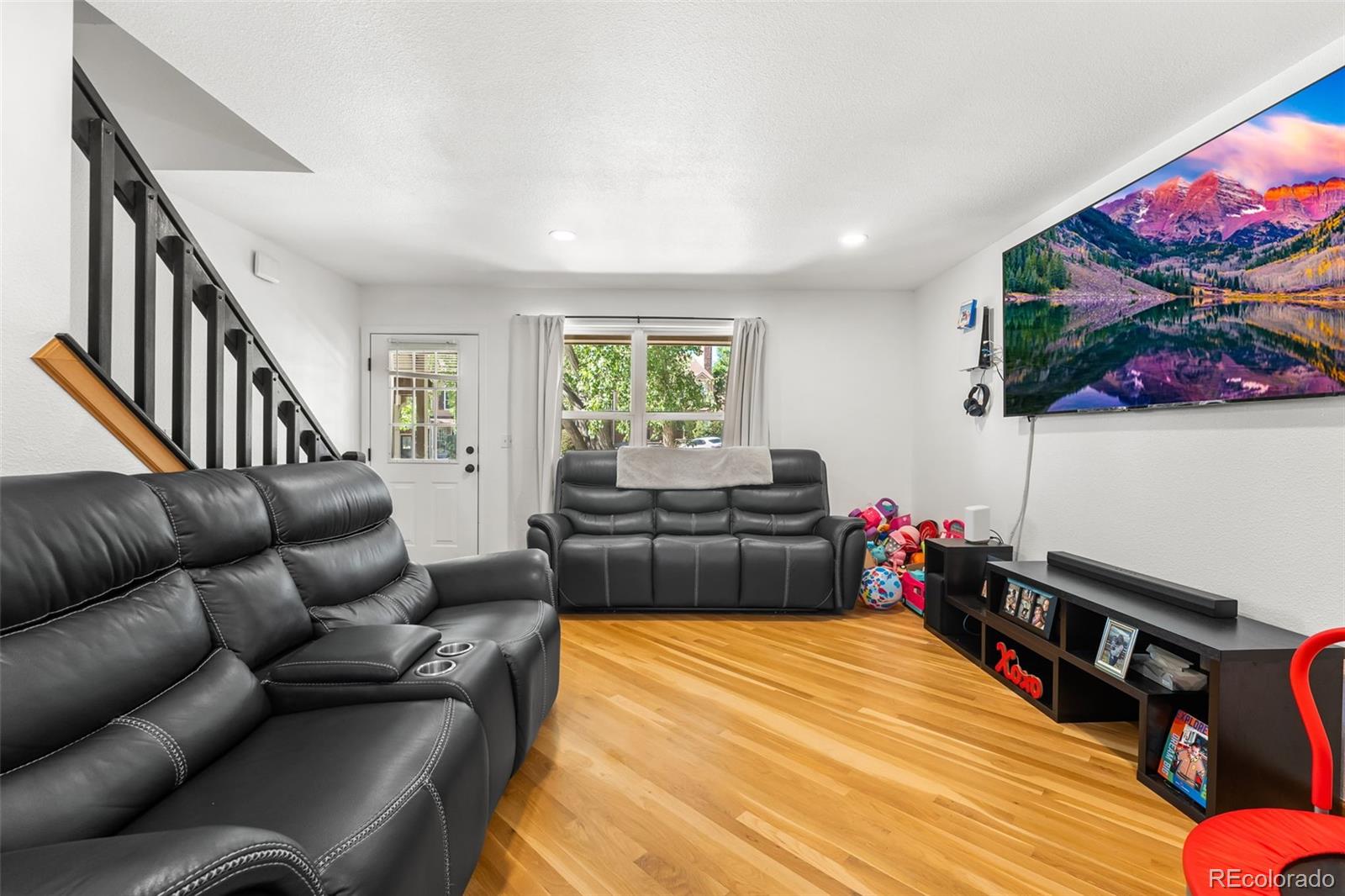152 Pheasant Run Louisville, CO 80027 - Photo 7 of 30 a living room with furniture a flat screen tv and a window