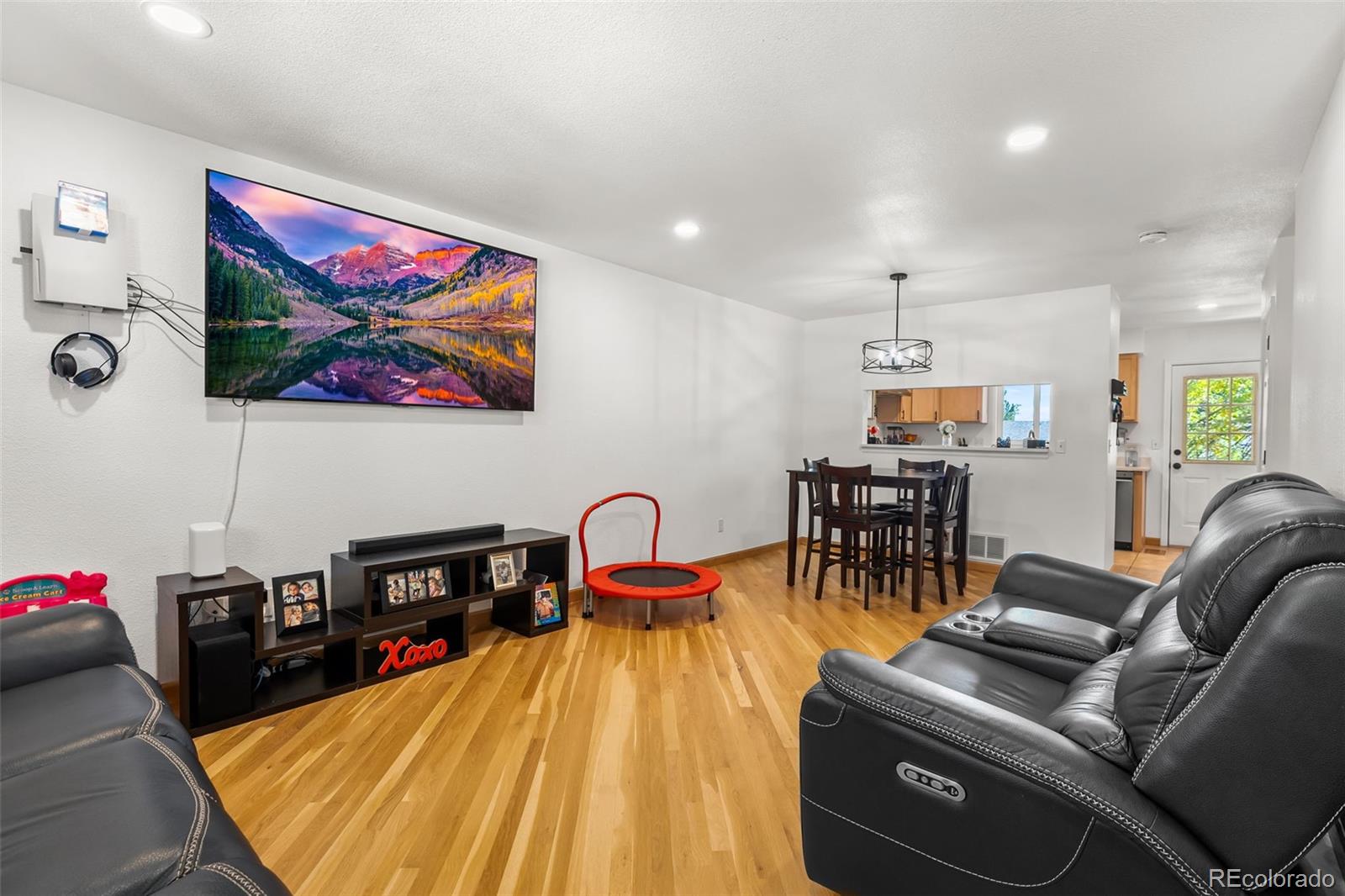 152 Pheasant Run Louisville, CO 80027 - Photo 10 of 30 a living room with furniture and a flat screen tv