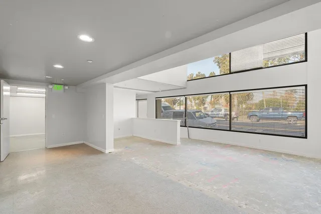 an empty room with large windows