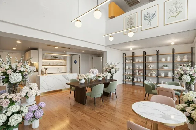 a living room with furniture kitchen view and a large window