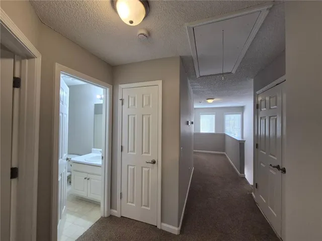a bathroom with a granite countertop sink a toilet a mirror and shower