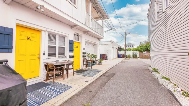 a view of a patio with table and chairs with wooden floor and fence