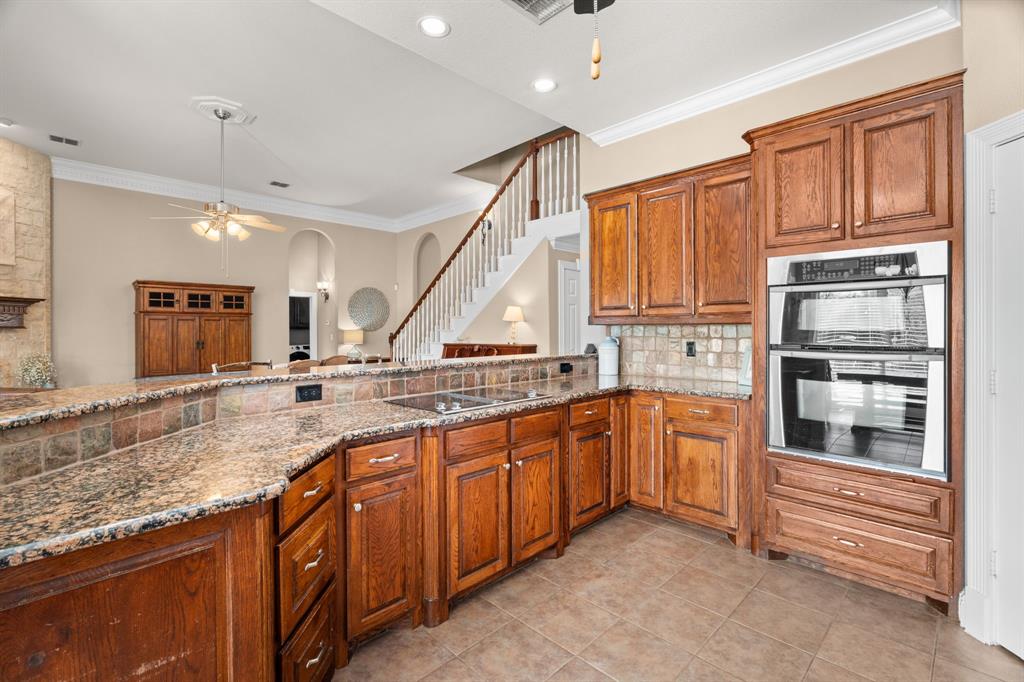 112 Waterfall Court Azle, TX 76020 - Photo 11 of 40 a kitchen with stainless steel appliances granite countertop a refrigerator and a sink