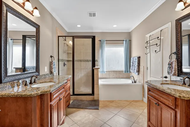 a bathroom with a granite countertop sink mirror and a bathtub