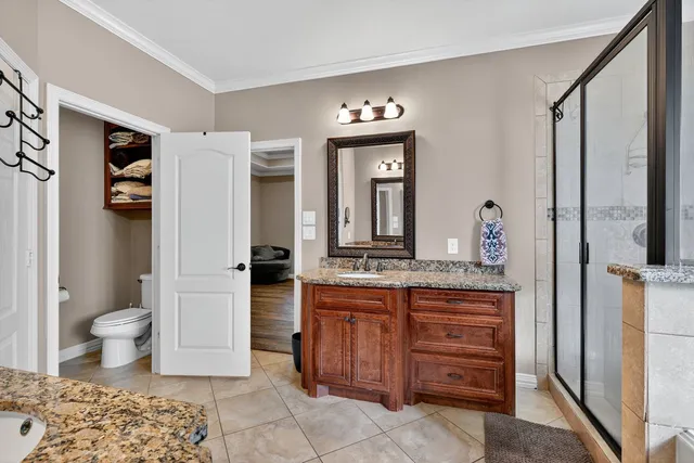 a spacious bathroom with a granite countertop sink and a mirror