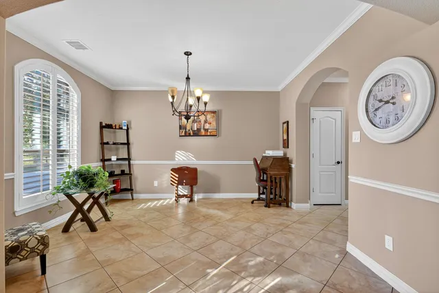 a view of a livingroom with furniture a chandelier and wooden floor