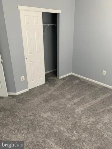 a view of a room with an empty space and a window