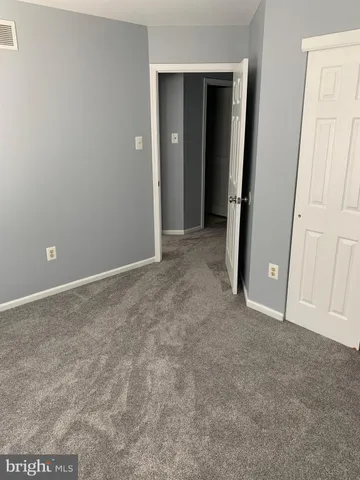 a front view of a house with a garden and plants