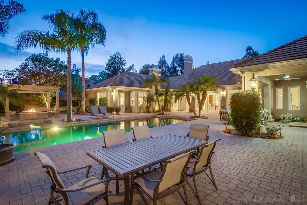 6867 Poco Lago Rancho Santa Fe, CA 92067 - Photo 14 of 52 a view of a patio with table and chairs under an umbrella