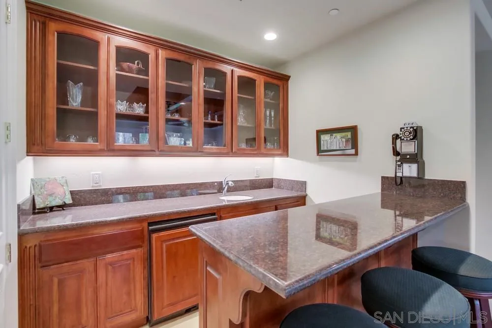 6867 Poco Lago Rancho Santa Fe, CA 92067 - Photo 26 of 52 a kitchen with granite countertop a sink and cabinets