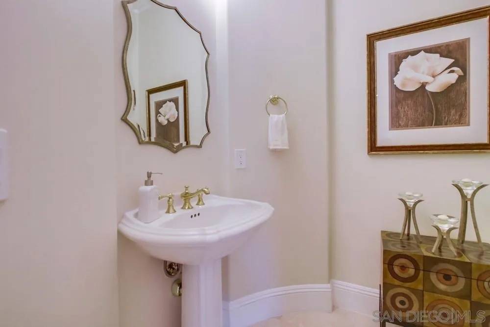 6867 Poco Lago Rancho Santa Fe, CA 92067 - Photo 27 of 52 a bathroom with a sink and a mirror