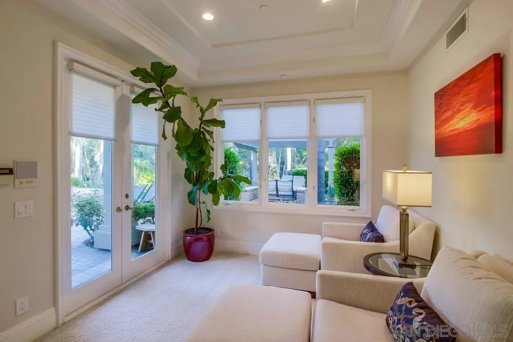 6867 Poco Lago Rancho Santa Fe, CA 92067 - Photo 36 of 52 a living room with furniture a chandelier and a window