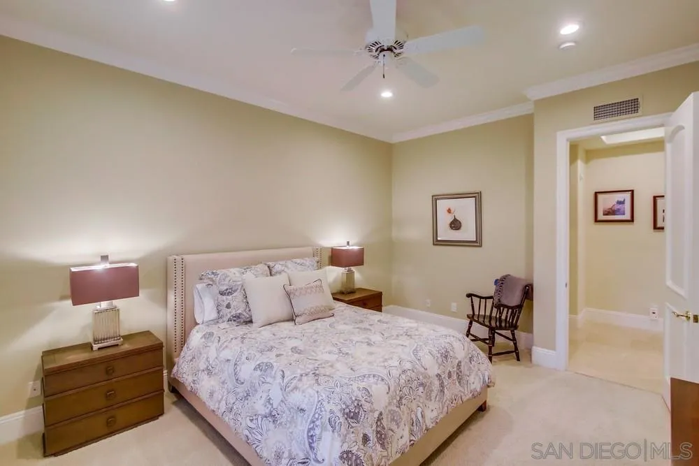 6867 Poco Lago Rancho Santa Fe, CA 92067 - Photo 41 of 52 a bedroom with a bed and lamp with window