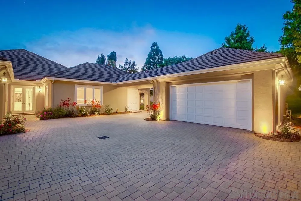 6867 Poco Lago Rancho Santa Fe, CA 92067 - Photo 10 of 52 a view of a house with a yard and a garage
