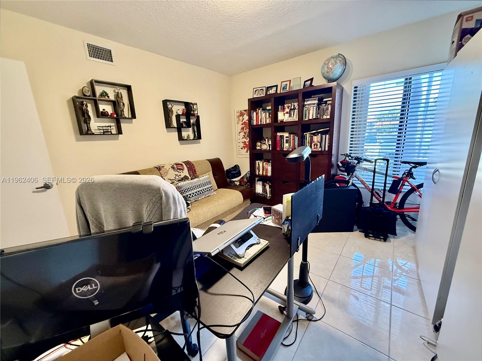 351 Club Circle, Unit 102 Boca Raton, FL 33487 - Photo 27 of 34 a living room with furniture and book shelf