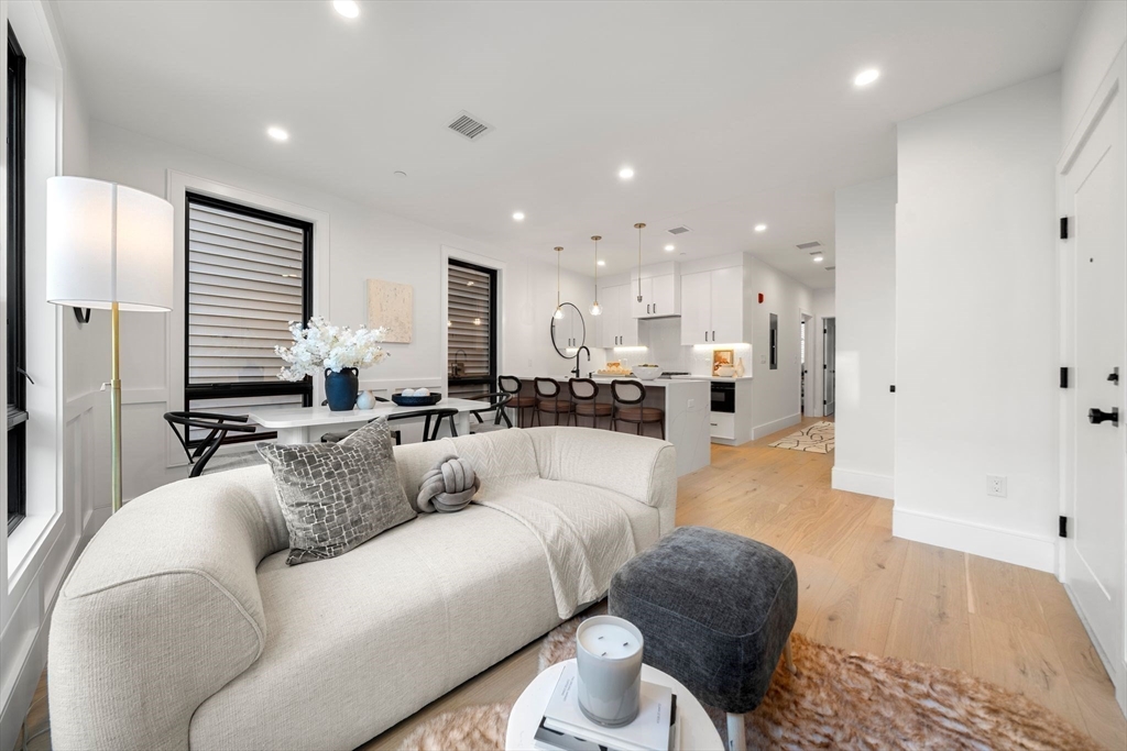 136 West 8th Street, Unit 2 Boston, MA 02127 - Photo 5 of 14 a living room with furniture and a view of kitchen